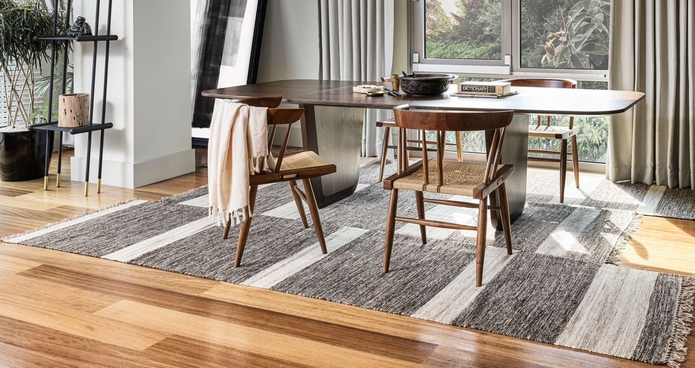 Asymmetric rug under dining table